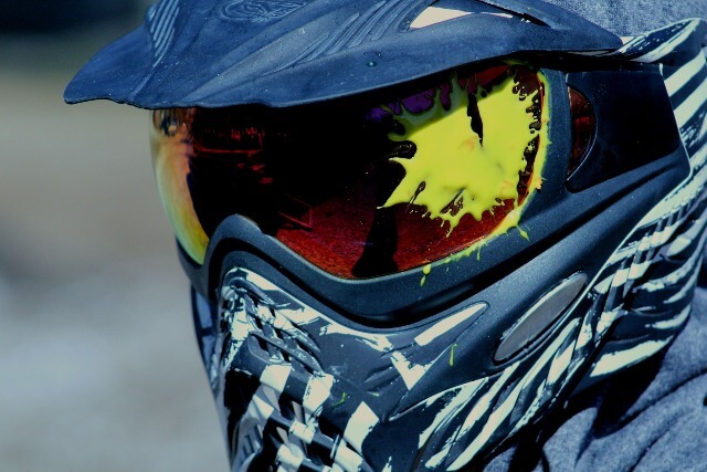 Mask and helmet with paintball splatter on goggles