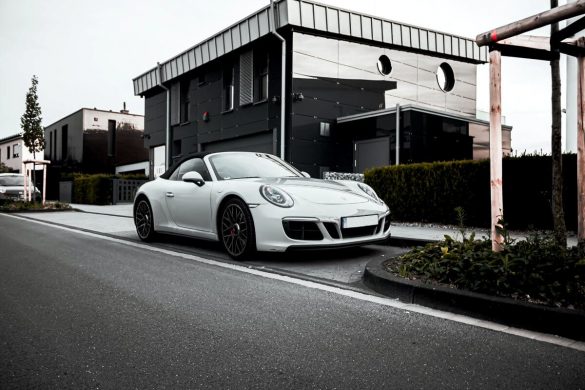 A luxurious car parked outside a home