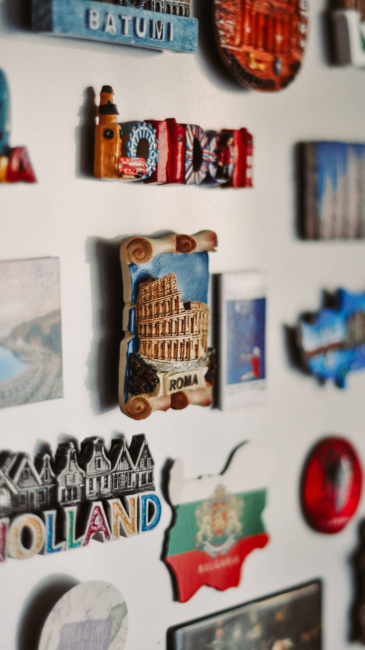 Travel destinations as magnets on a white fridge